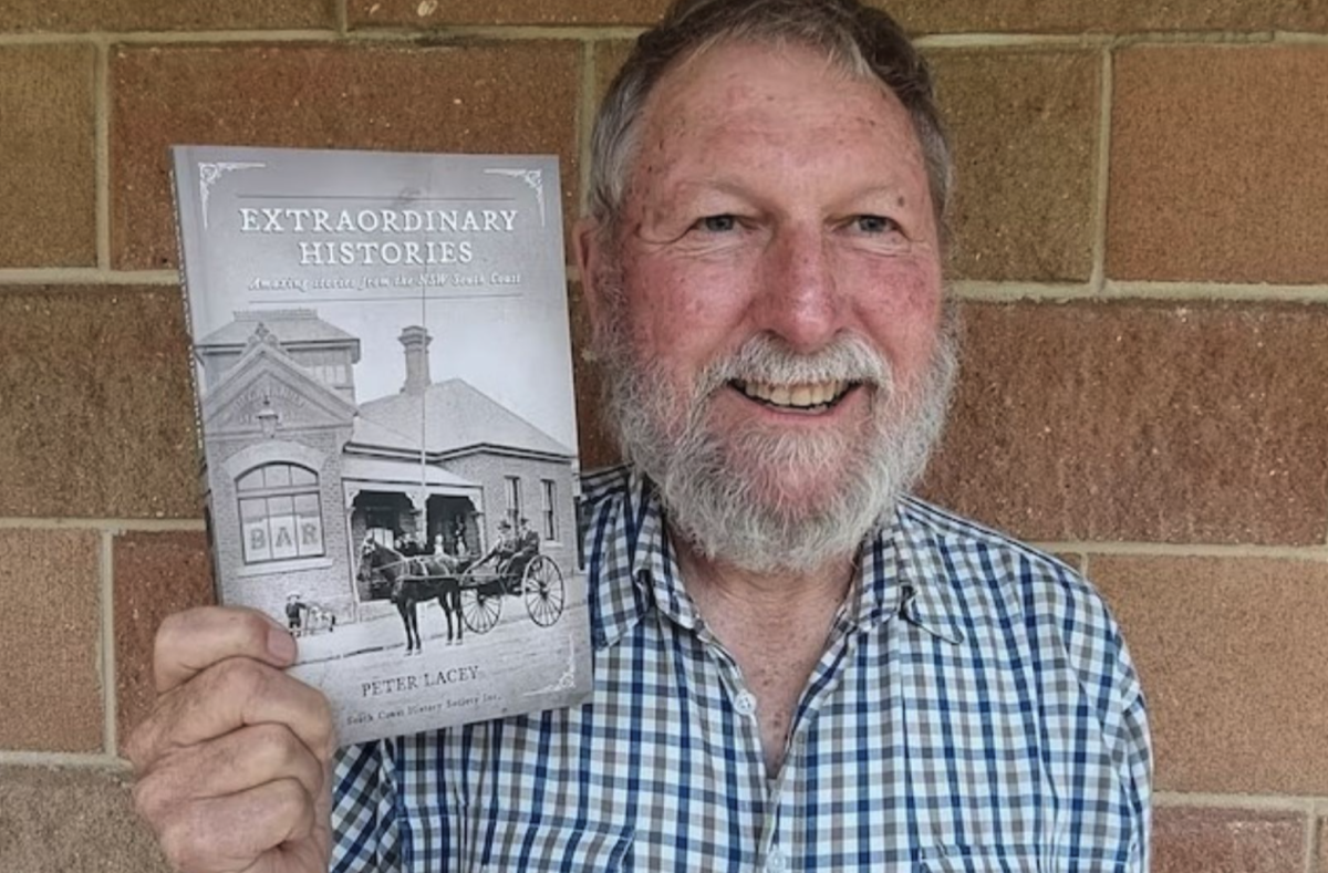 President of the South Coast History Society Peter Lacey holds up his book Extraordinary Histories